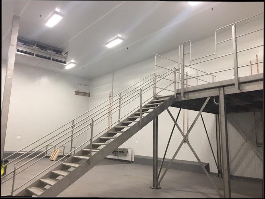 Commercial interior with a steel mezzanine stair and new recessed LED panel lighting