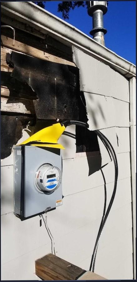 Electricity meter remounted after damage to the wall behind it